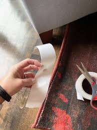 keep rugs in place using carpet tape