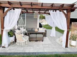 wood pergola with white patio curtains