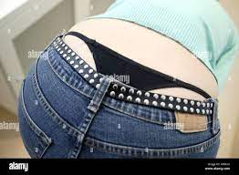 Girl bending over revealing her g string under pants Stock Photo - Alamy