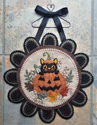 cat in a pumpkin wool applique penny rug