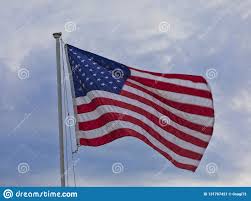 American Flag On A Pole With Light Clouds And Sky Stock