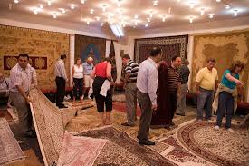 people looking at carpets at a rug