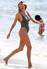 Candice Swanepoel flaunts her enviable curves in low-cut swimsuit | Daily  Mail Online