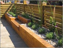 raised garden beds along fence small