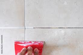 using trowel repairing old tile grout