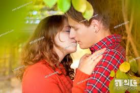 happy young couple kissing in a park