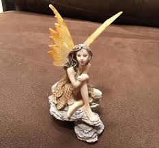 Garden Fairy With Golden Wings Sitting