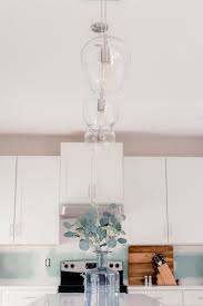 Contemporary pendant lights hanging over kitchen island. Tips For Choosing Installing Kitchen Pendant Lights La La Lisette