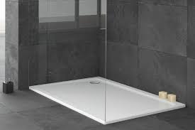 a shower tray on a concrete floor