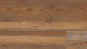 Instead of using a transition piece where the two floors meet, pull the carpet tight and wrap the edge underneath. Appalachian Pine Luxury Vinyl Plank Flooring Coretec Plus Xl