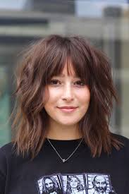 The layers are set outwards to add texture. 50 Best Hairstyles With Bangs For 2021