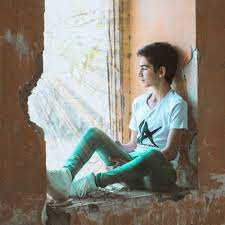Boy Sitting Near Wall · Free Stock Photo