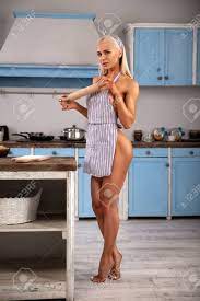 Beautiful Blonde Girl Housewife Posing Nude On The Kitchen In Sexy Apron  With A Rolling Pin - Beauty Glamour Portrait. Фотография, картинки,  изображения и сток-фотография без роялти. Image 115544223