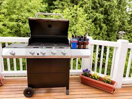 a charcoal grill on a wood deck