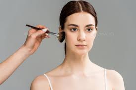 makeup artist holding cosmetic brush