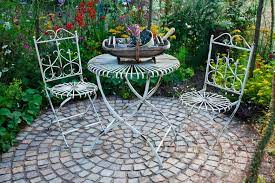 cobblestone patio surrounded by garden