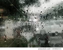 Raindrop On Glass Window In Rainy