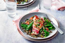 bacon wrapped fish with creamy lentils