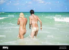 two adults are playing naked in a nude beach Stock Photo - Alamy