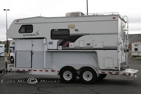a truck camper on a flatbed trailer