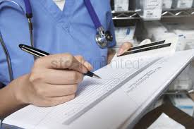Female Doctor Writing In Patient Chart Mid Section Stock