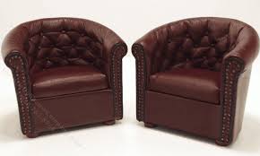 pair of burgundy leather tufted chairs