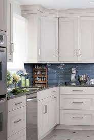 This kitchen was designed by mikal otten. White Kitchen Cabinets With Blue Glass Tile Backsplash Transitional Bathroom