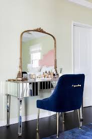 dark blue velvet chair at mirrored
