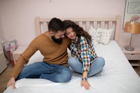 Young Couple Ing New Bed