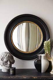black convex mirror with aged gold