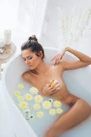 Nude Woman Lying in Bathtub With Water and Flowers · Free Stock Photo