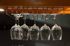 wine glasses hanging from ceiling in a