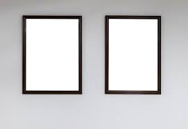Two Empty Picture Frames On A White Wall