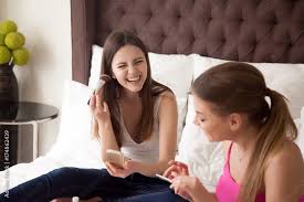 young smiling friends doing makeup