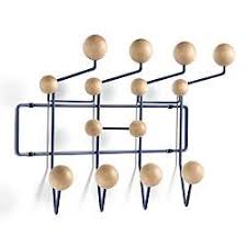 Create an art feature out of a coat rack, with this line of alternating black piano wall hooks: Modern Space Savers Coat Racks Hooks Ylighting