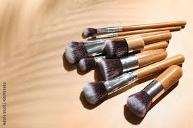 set of wooden makeup brushes and palm