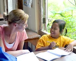 Image result for photos of volunteers teaching reading