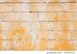 Old Brick Wall With Yellow Paint