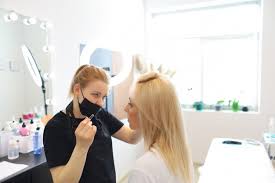 eyebrow master stands in black clothes