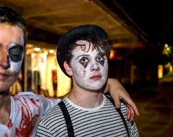 man wearing mime costume and makeup by