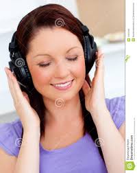 Stock Photo: Blissful woman listening to music - blissful-woman-listening-to-music-15647600