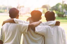 three man hugging at sunset concept of