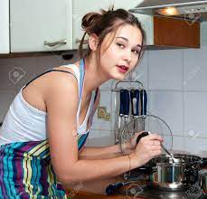 Young Beautiful Asian Housewife Cooking On The Kitchen Stock Photo, Picture  And Royalty Free Image. Image 11865643.