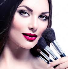 woman with makeup brushes stock photo