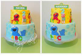 A Sesame Street Themed Birthday Cake With Fondant Cut Outs Displayed  gambar png