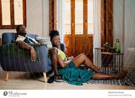 black couple relaxing in living room