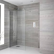 The geometric pattern breaks up the long, grey tiles across the floor of the bathroom to add texture and character. The Essential Guide To Walk In Showers And Wet Rooms