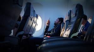person sitting inside airplane using