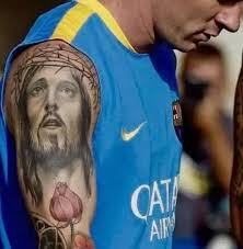 A tattoo of jesus' face with a crown of positions of royalty sits upon this football legends right arm. When Did Messi Get His Tattoos Quora