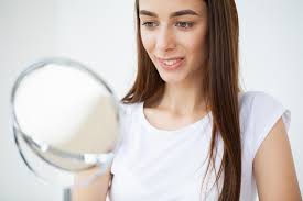 young woman applying makeup